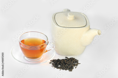 White teapot, a cup of Oolong tea and dried tea leaf, chinese traditional.