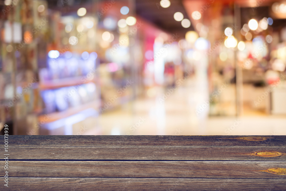 empty blank wood table and colorful blur department store