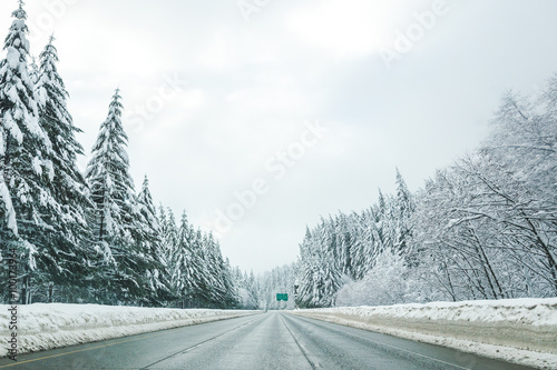 Empty road with high snow level covered landscape in winter season.