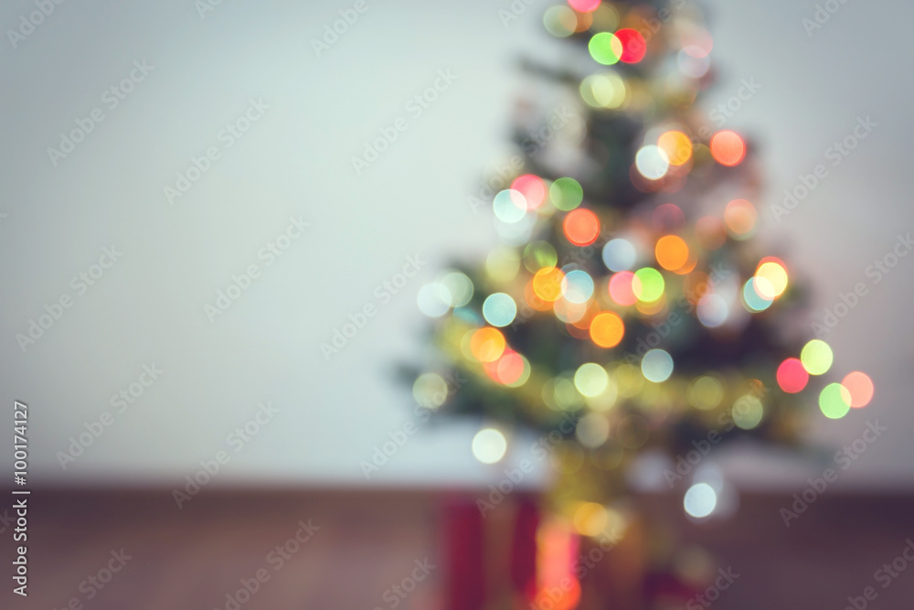 Fototapeta premium blur background, light celebration on christmas tree with gift box in living room