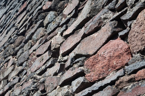 Detail view of a stone wall background. Selective focus