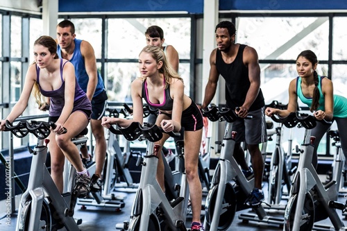 Fit people working out at spinning class