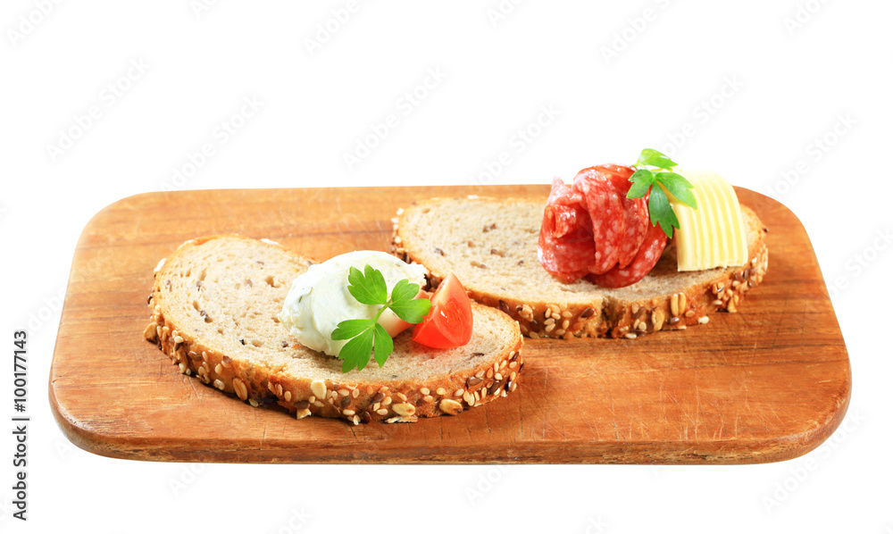Bread with cheese spread and salami