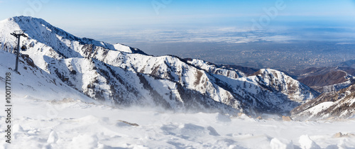 Mountains under the snow in winter. Panorama of snow mountain range landscape with blue sky. © kulikovan