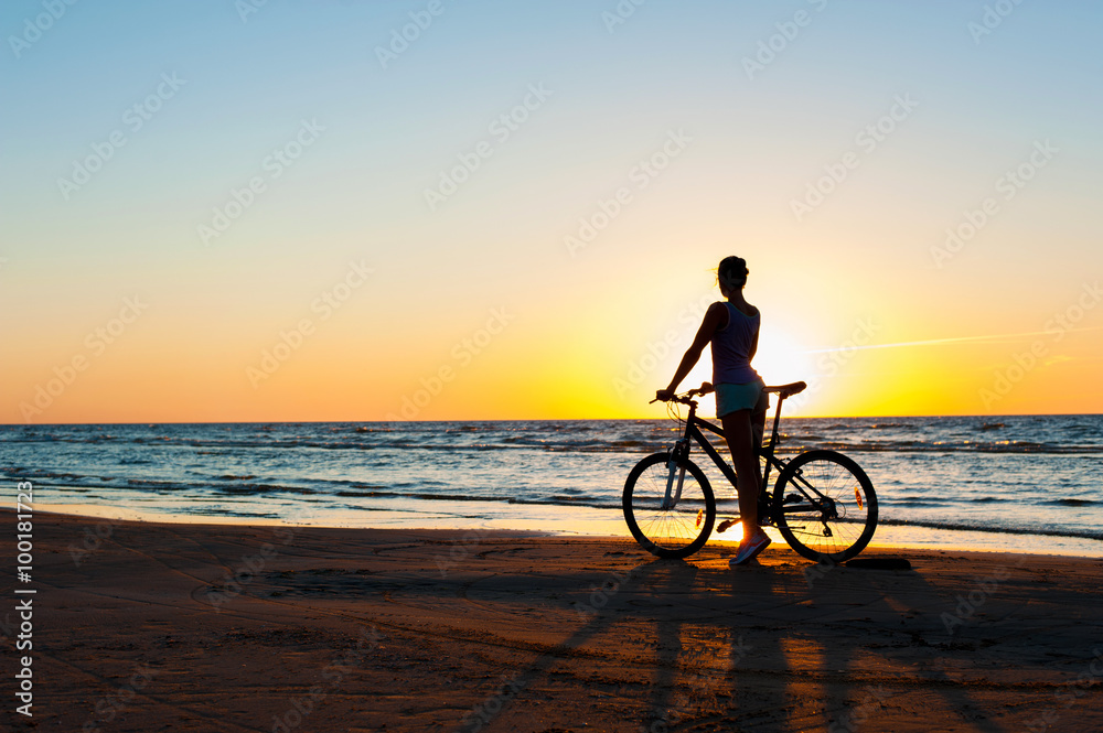 Moment in time. Sporty woman cyclist silhouette on multicolored Moment in time. Sporty woman cyclist silhouette on multicolored