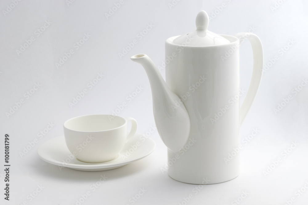 A white coffee pot and a cup