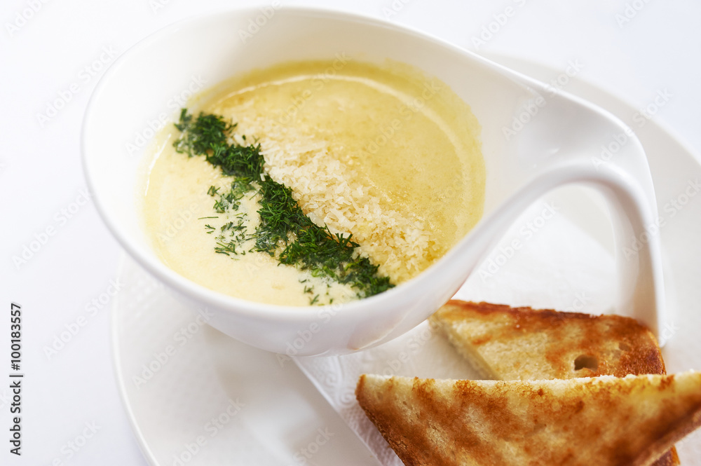 Cream soup cheese on white plate studio shot Cream soup cheese on white plate studio shot