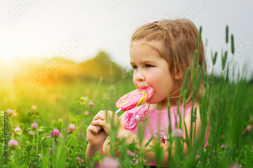  little girl eating a lollipop