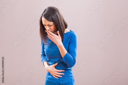 Obraz na plátně Portrait of young woman who is having pain in her stomach.