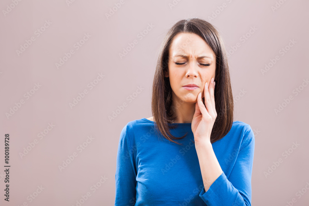 Portrait of young woman who is having toothache. Portrait of young woman who is having toothache.