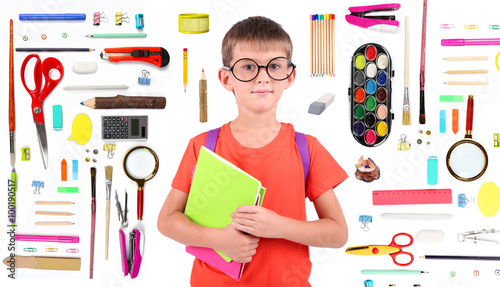 Cute schoolboy with supplie...