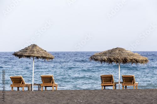 view of Perissa beach on the Greek island of Santorini with sunb