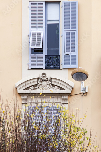 NICE, FRANCE, on JANUARY 7, 2016. Typical architectural details of houses in historical part of the city. Window and balcony. photo