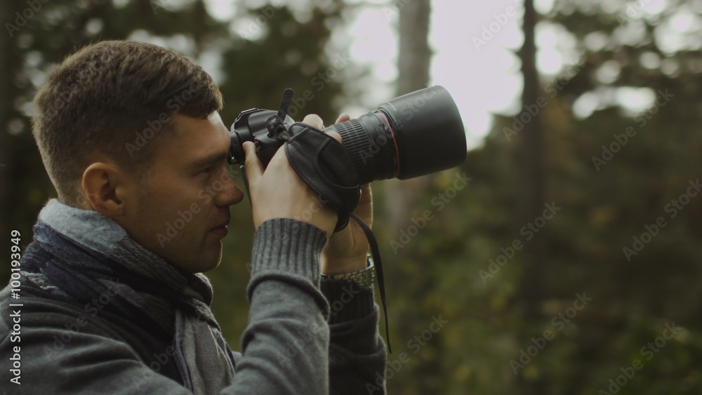 Male photographer is taking photographs in a forest at autumn time. Shot on RED Cinema Camera. Male photographer is taking photographs in a forest at autumn time. Shot on RED Cinema Camera.