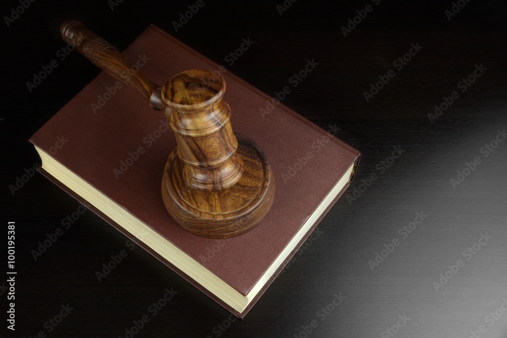 Judges Or Auctioneers Gavel And Red Book On Black Table