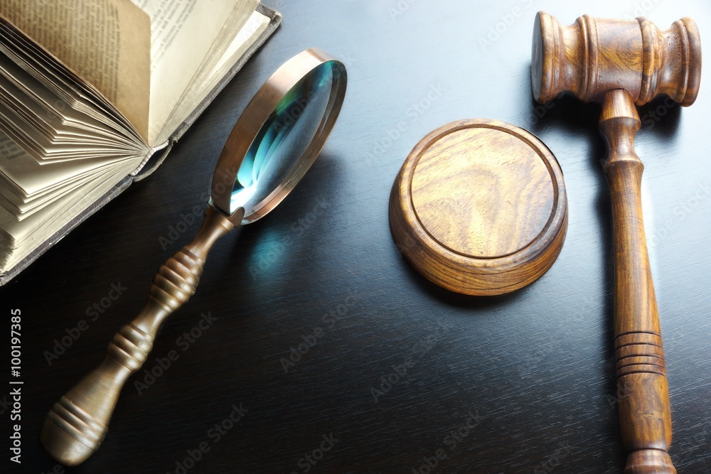 Judges Gavel, Magnifier And Old Book On The Black Table Judges Gavel, Magnifier And Old Book On The Black Table