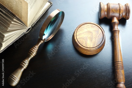 Judges Gavel, Magnifier And Old Book On The Black Table