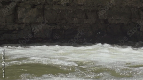 Rushing stream and rocky riverbank. photo