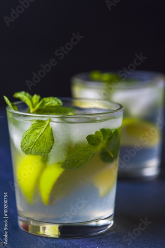Glasses of lemonade with lemon and lime slices