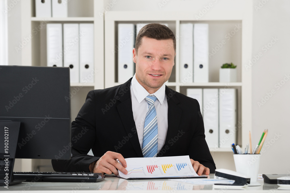 Happy businessman Analyzing Financial Charts Happy businessman Analyzing Financial Charts