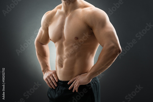 Muscular Man Standing With Hands On Hip