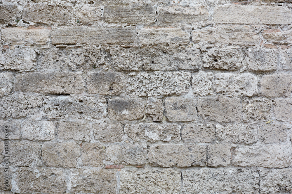 Gray, weathered stone blocks wall texture background