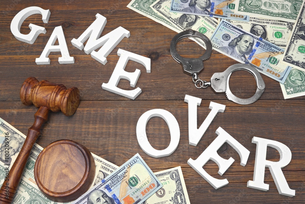 Sign Game Over, Money, Handcuffs, Judges Gavel On Wood Background