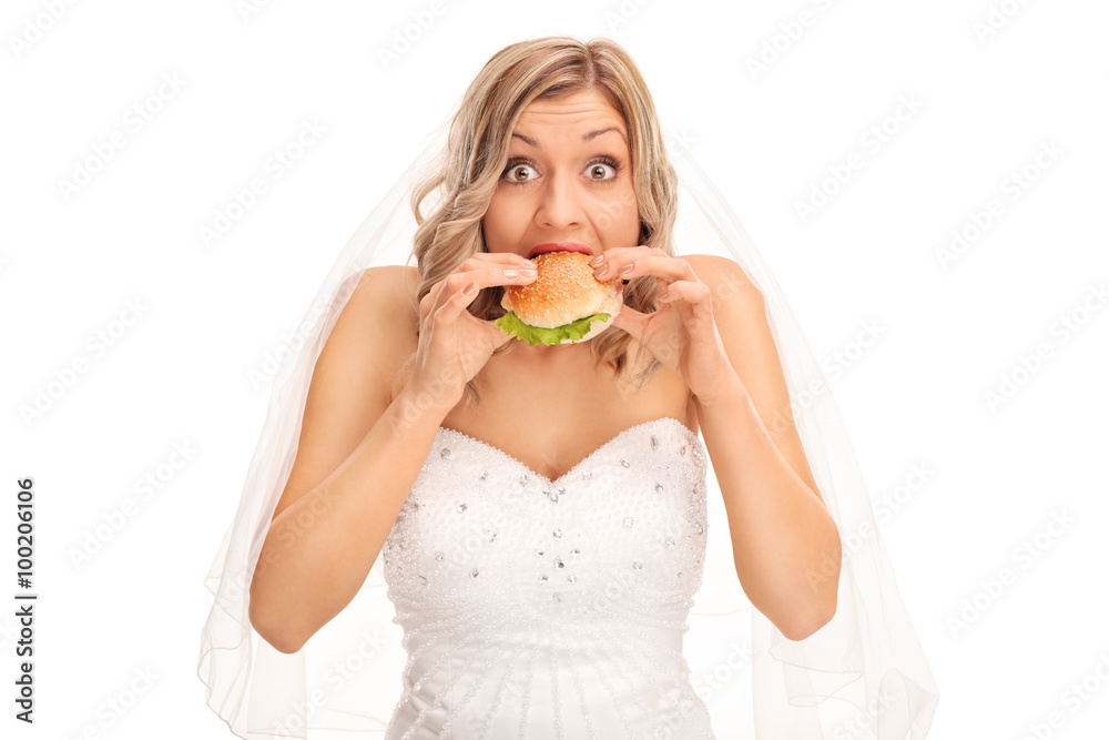 Surprised blond bride eating a sandwich Surprised blond bride eating a sandwich