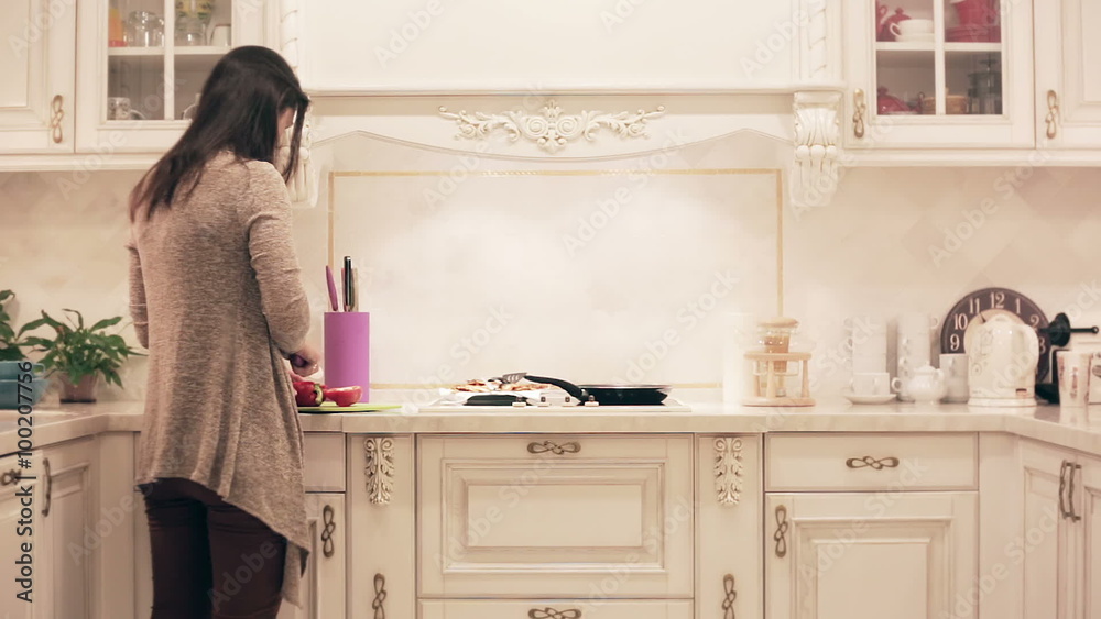 girl preparing a meal in the kitchen. time lapse girl preparing a meal in the kitchen. time lapse