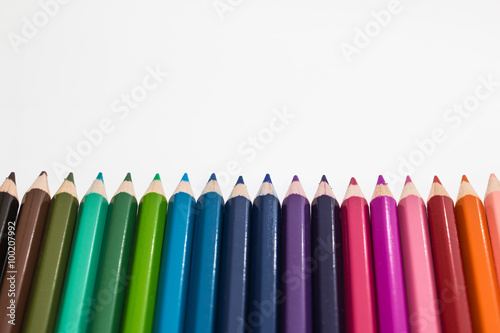 line of colour pencils white background
