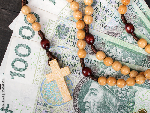 Closeup of a wooden rosary on Euro banknotes