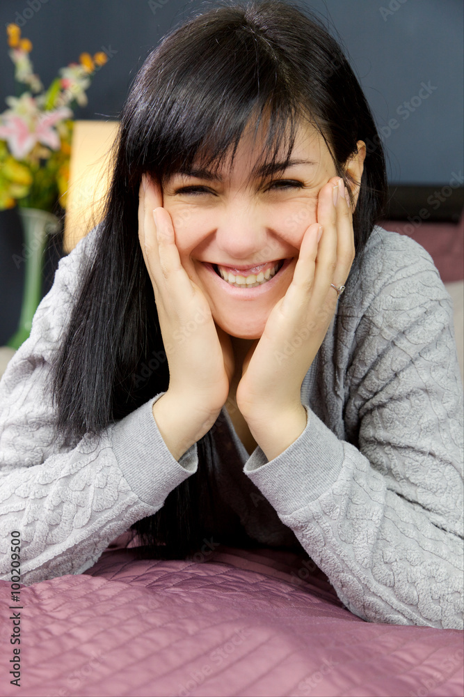 Cute happy woman smiling looking camera lying in bed Cute happy woman smiling looking camera lying in bed