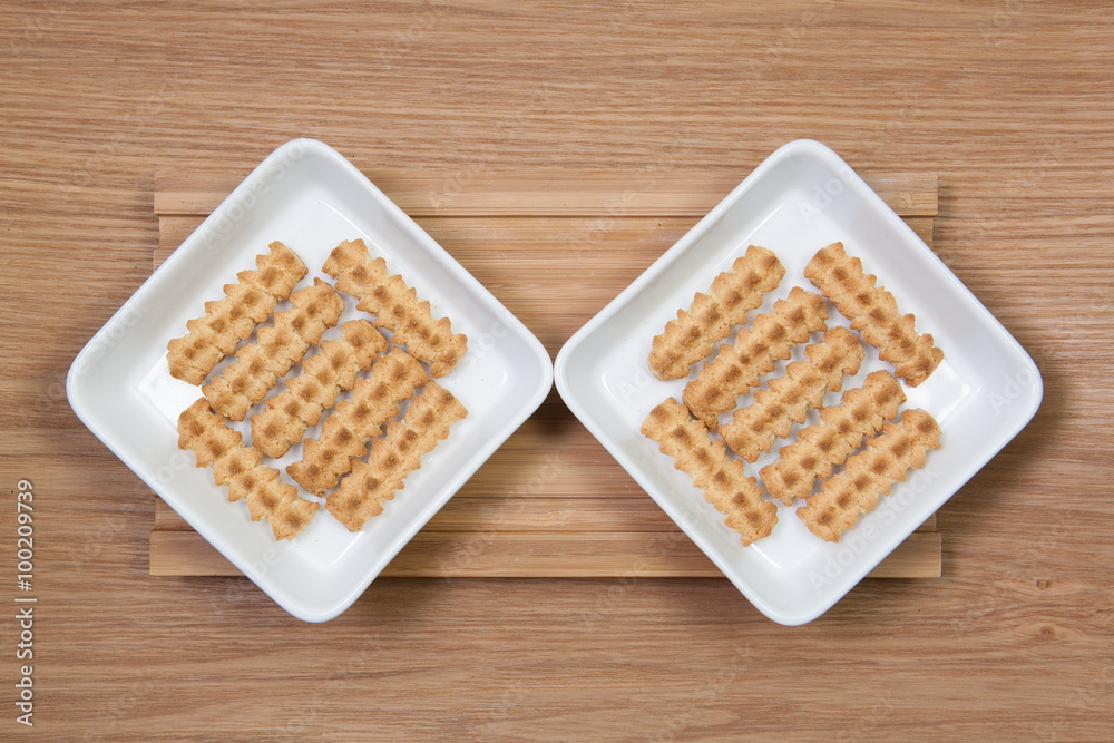Biscuits in ceramic bowls on a wooden desk