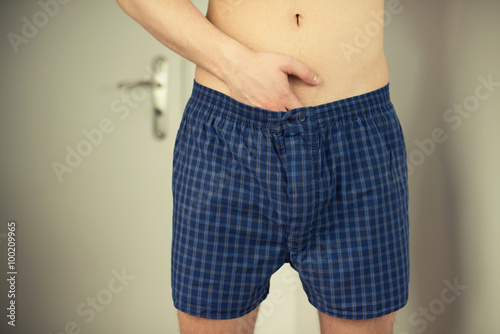 фотографія Man putting hand in underwear