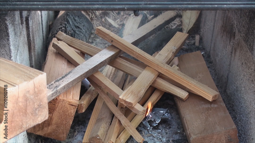 Starting fire in fire pit made of building blocks. Starting fire in fire pit made of building blocks.