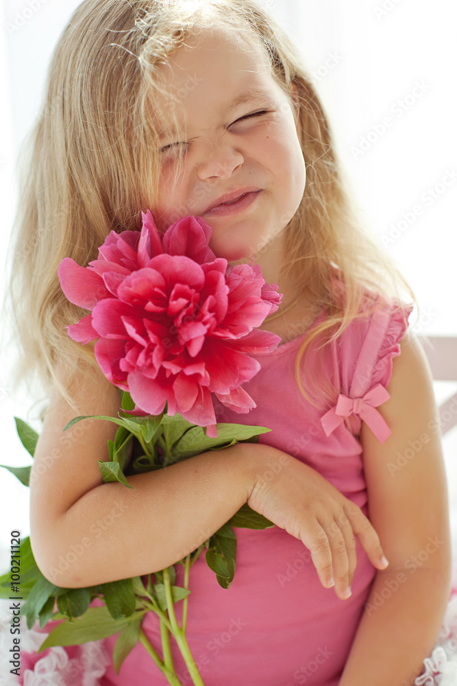 Happy little girl with a flowers bouquet 