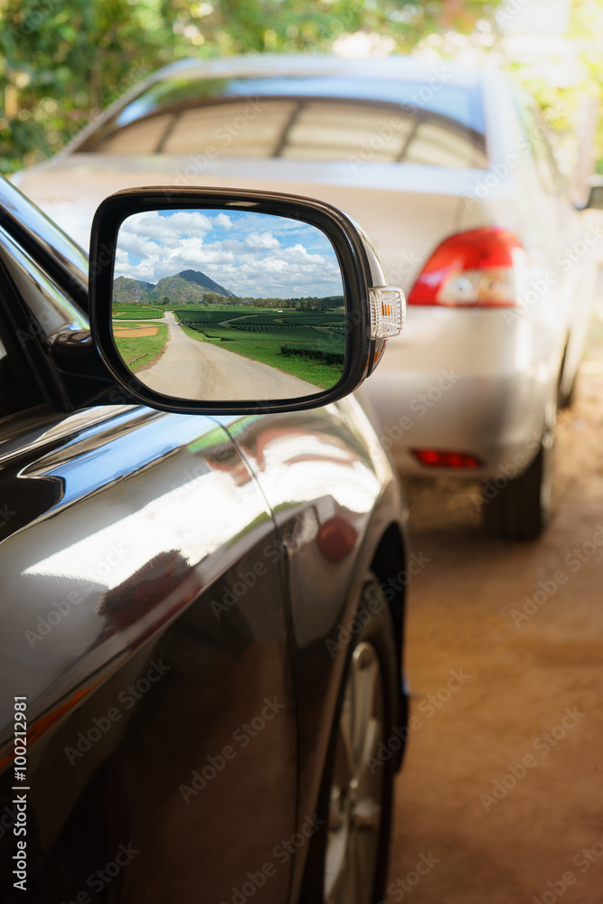 Green nature with road view in Rearview mirror