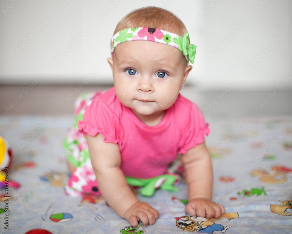 a little baby in pink shirt creeping a little baby in pink shirt creeping