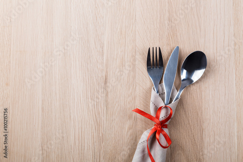 Fork, spoon and knife tied with a red ribbon