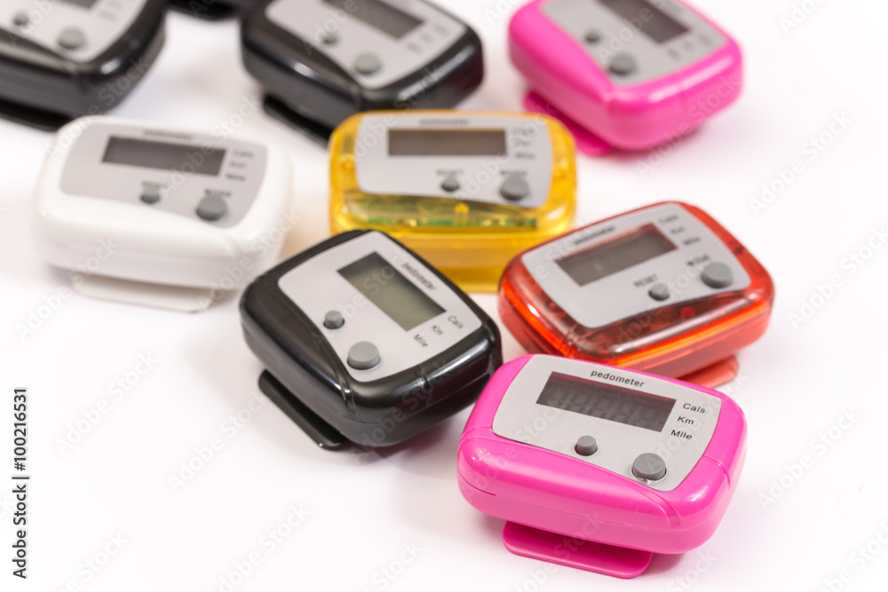 Colorful pedometers over white background