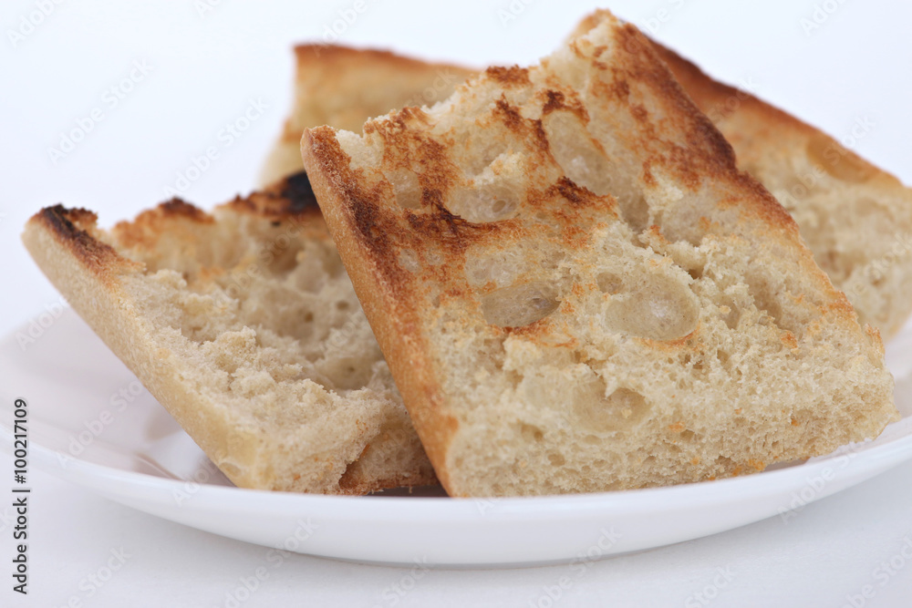 close up of pieces of toast on a white plate