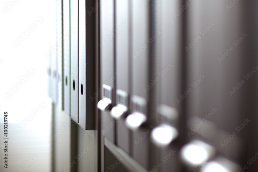 File folders, standing on shelves in the background File folders, standing on shelves in the background
