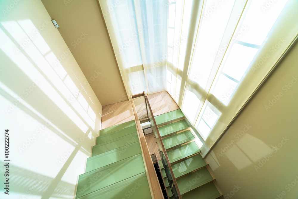 Glass and wooden stairs in modern home interior Glass and wooden stairs in modern home interior