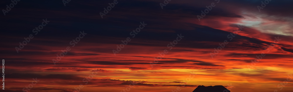 Panoramic view of a beautiful bright sunset with cloudy sky