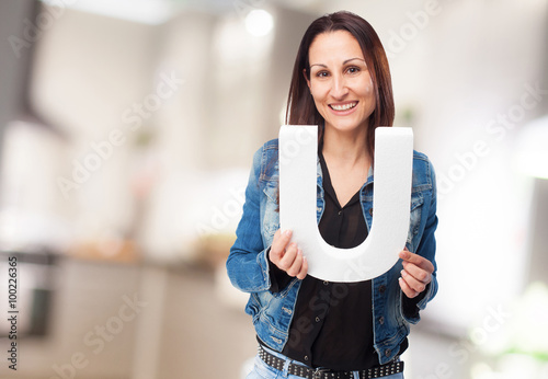 woman holding the U letter