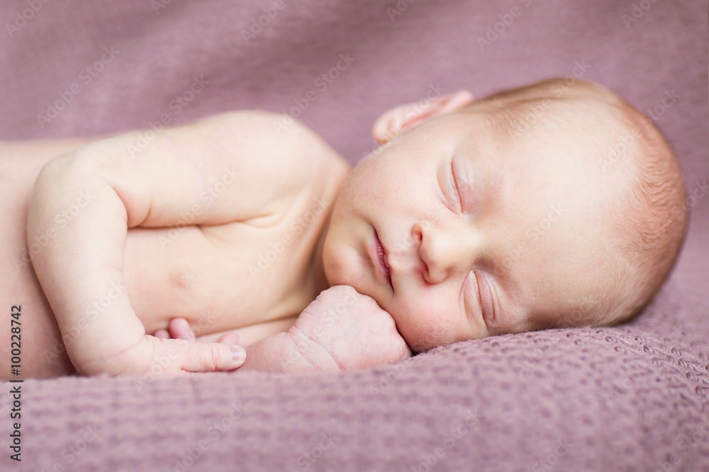 adorable little newborn boy lying on the brown blanket adorable little newborn boy lying on the brown blanket