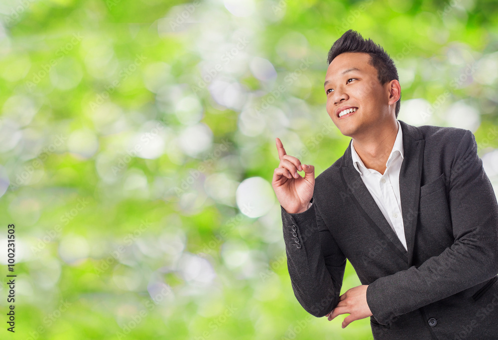handsome young asian man pointing up with finger handsome young asian man pointing up with finger