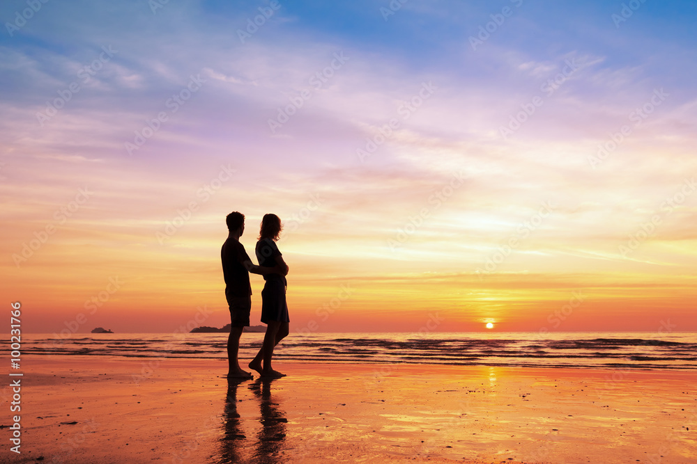 Couple sharing a romantic moment together on the beach, sunset