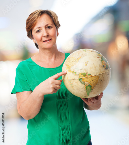 portrait of a mature woman holding a earth globe