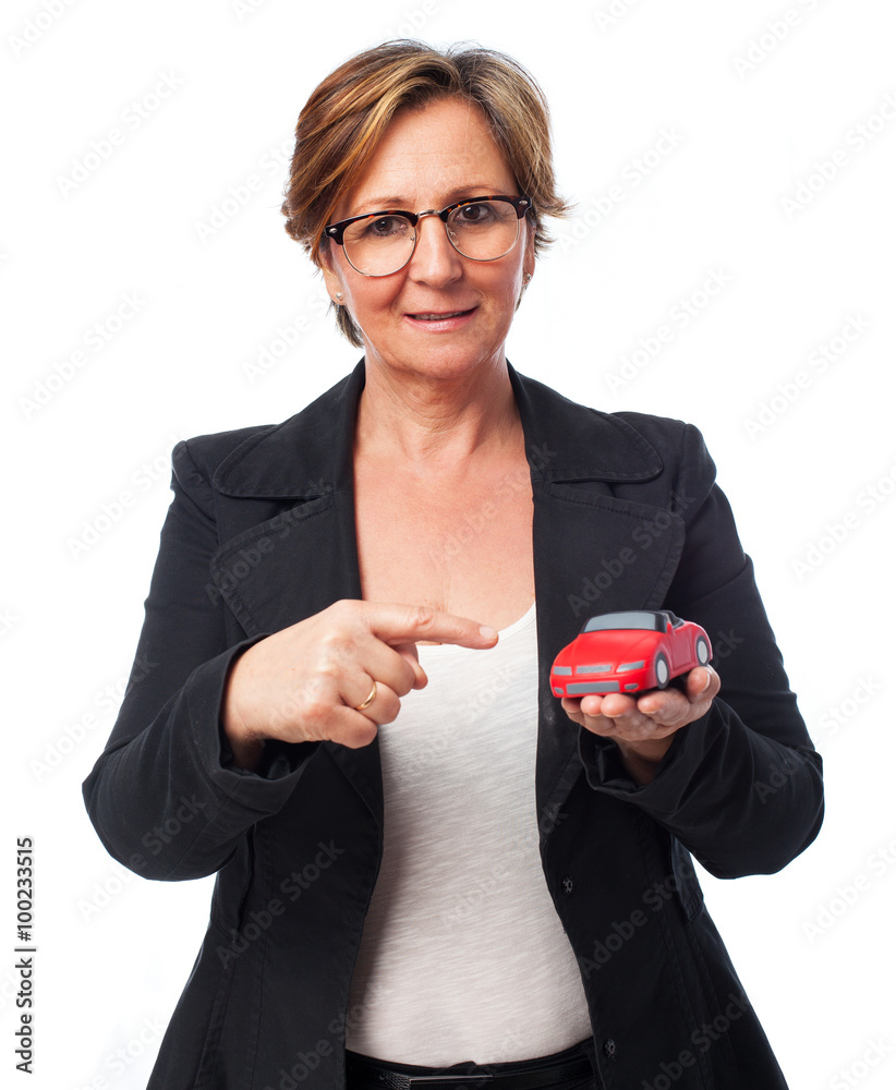 portrait of a mature business woman holding a red car portrait of a mature business woman holding a red car